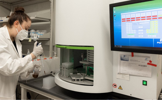 lab technician using extraction tool in lab